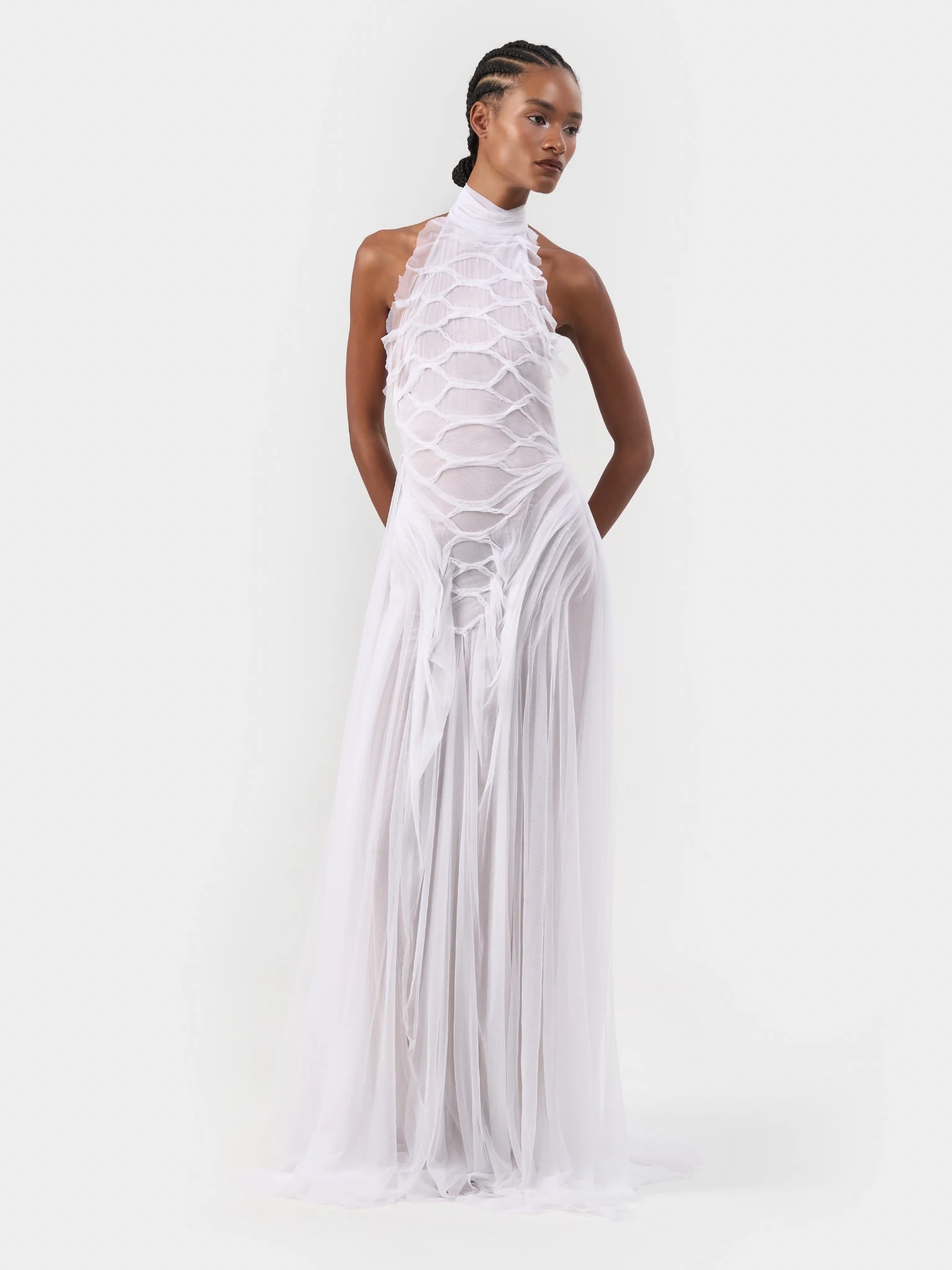 Model in a white halterneck bridal gown with gathered translucent fabric