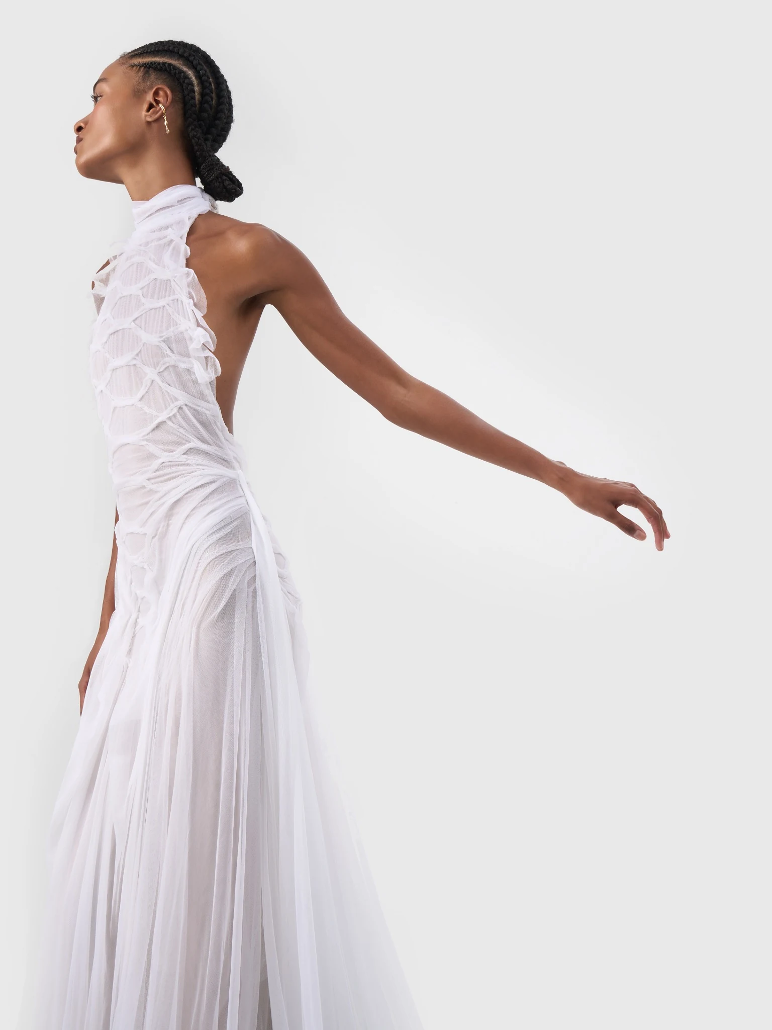 Side portrait showing the draped texture of a white halterneck bridal gown
