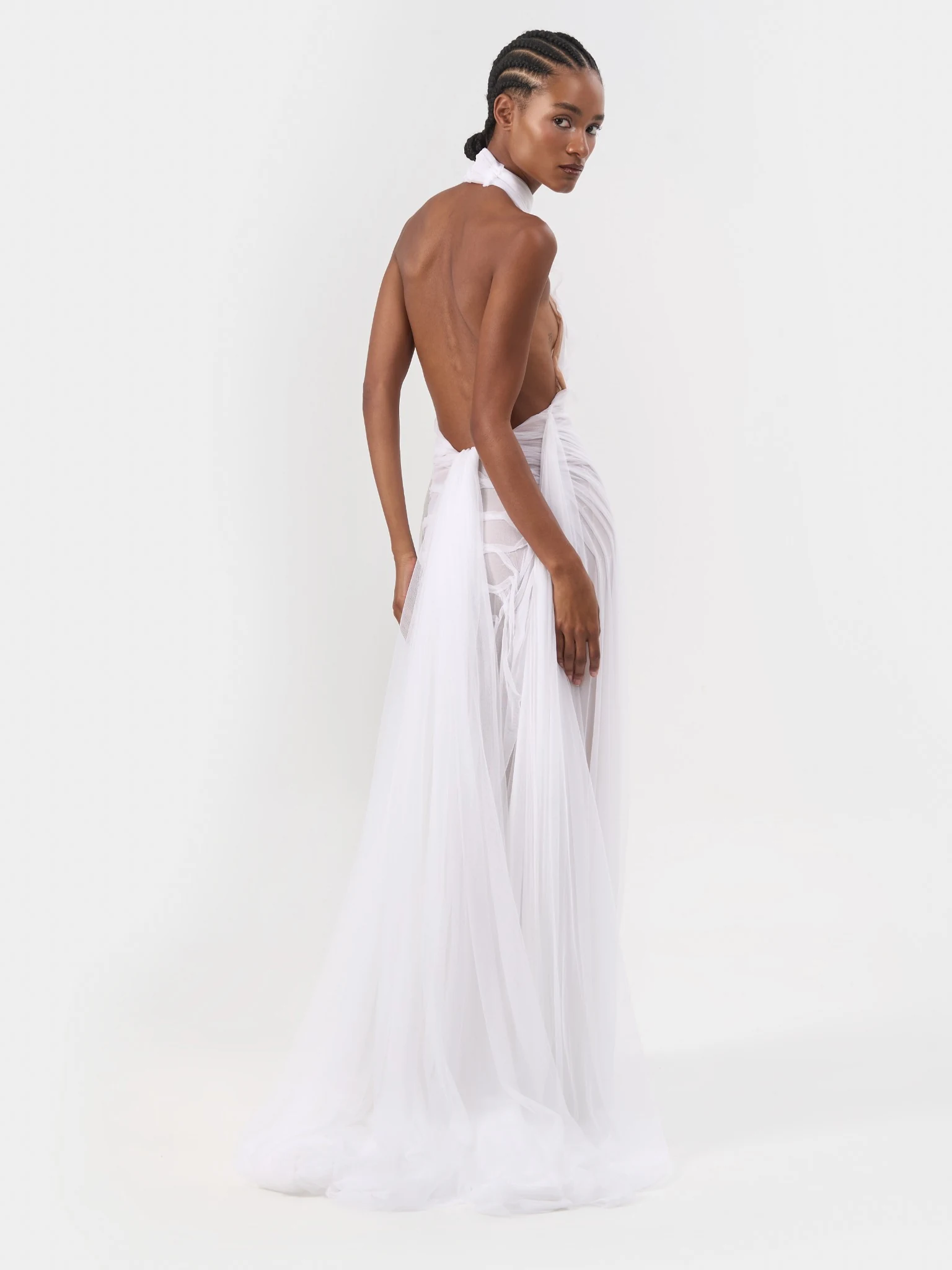 Back view of a white halterneck bridal gown with an open back