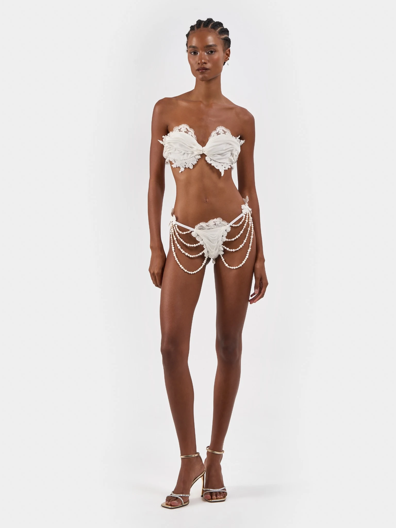 Front view of white bridal separates with lace and draped pearl details