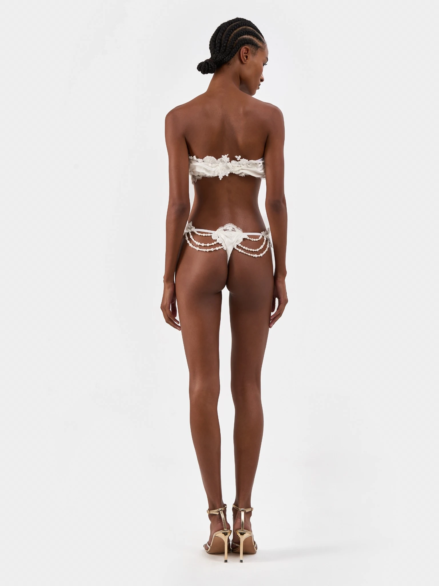 Back view of white bridal separates with lace and pearl details